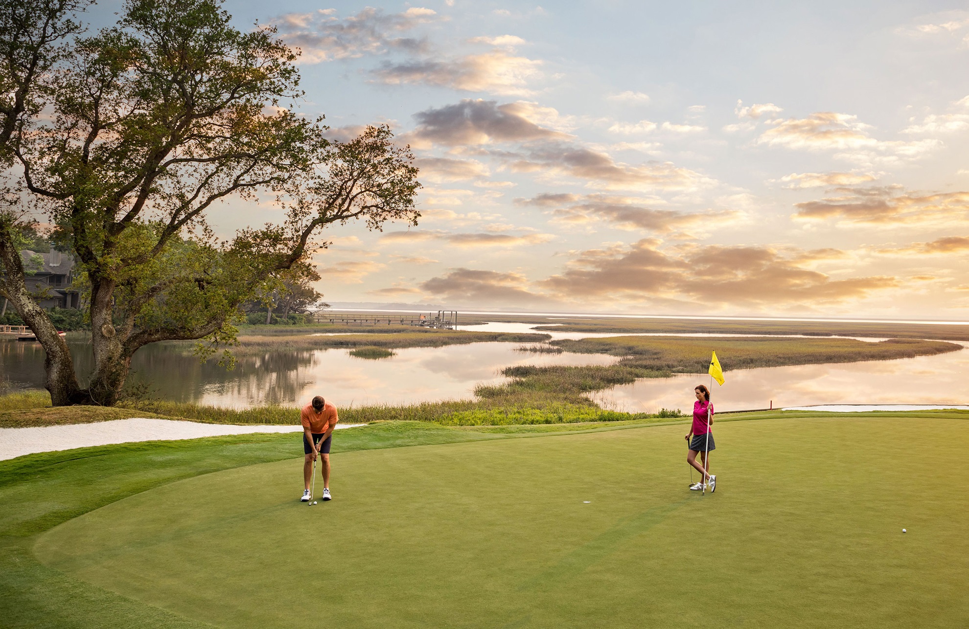 Two golfers putting at Amelia Island.
